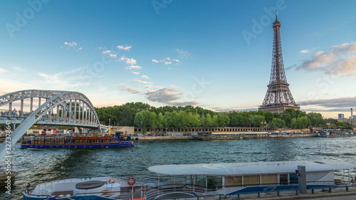 Eiffel tower with Debilly Footbridge and Jena bridge over Seine river day to night timelapse, Paris, France photo