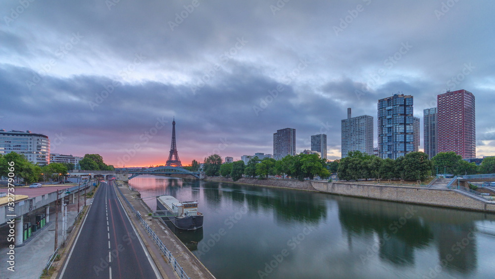 Eiffel Tower sunrise timelapse with boats on Seine river and in Paris, France.