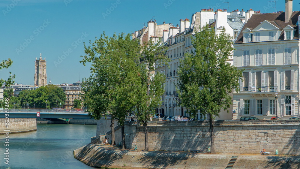 Saint-Louis bridge timelapse with houses on Orleans embankment. Paris, France.