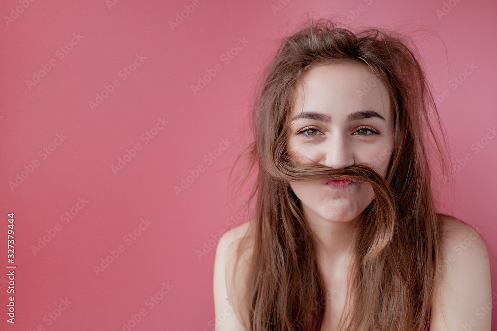 Girl shows scissors on hair, haircare concept Girl shows scissors on hair, haircare concept