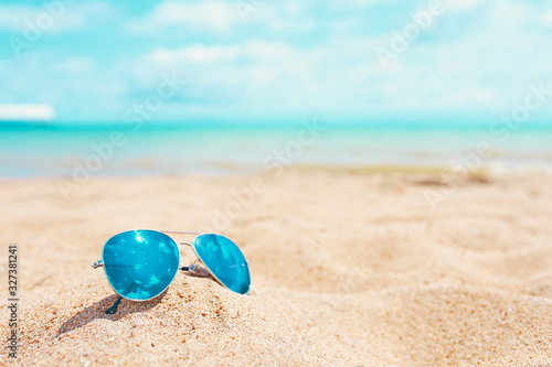 Sun glasses on Sand Beach Summer Holiday Travelling background.