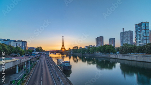 Eiffel Tower sunrise timelapse with boats on Seine river and in Paris, France. © neiezhmakov