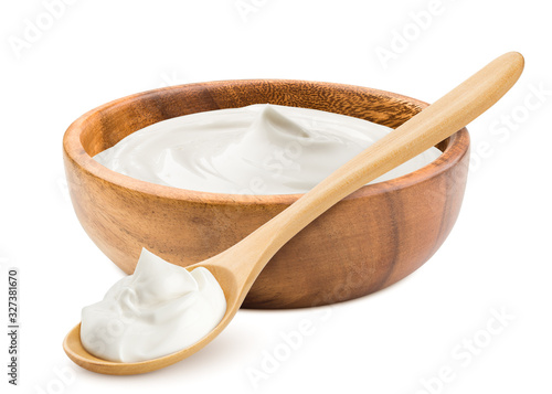 sour cream in wooden bowl and spoon, mayonnaise, yogurt, isolated on white background, clipping path, full depth of field photo