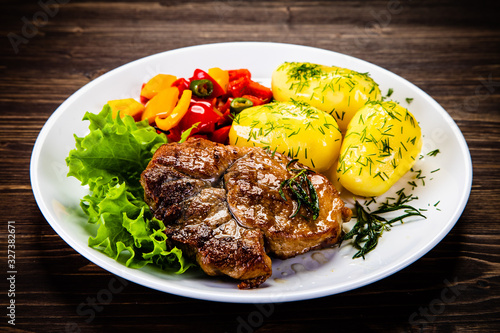 Grilled steak with boiled potatoes and vegetables