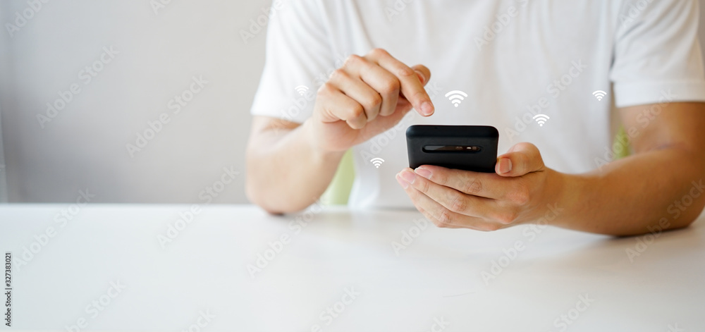 close up businessman hand holding smartphone and go to setting for turn on wifi connection to playing multimedia on cyber internet network at home , lifestyle people with comfortable technology close up businessman hand holding smartphone and go to setting for turn on wifi connection to playing multimedia on cyber internet network at home , lifestyle people with comfortable technology