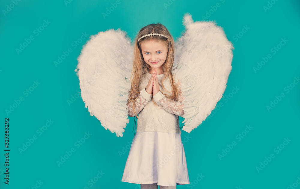 Valentines Day. Angels little hands crossed for you. Mischievous little angel girl standing with your clenched fists. Beautiful little angel girl standing with your arms close to your chest as in Valentines Day. Angels little hands crossed for you. Mischievous little angel girl standing with your clenched fists. Beautiful little angel girl standing with your arms close to your chest as in