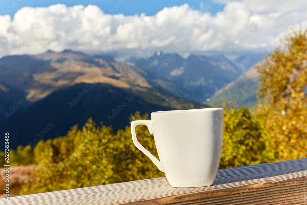 cup on a background of mountains cup on a background of mountains