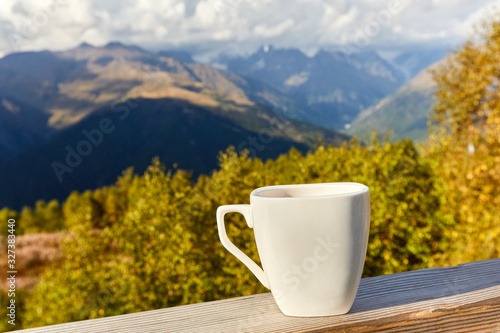 cup on a background of mountains