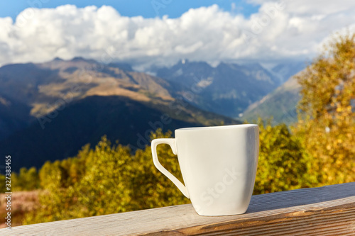 cup on a background of mountains