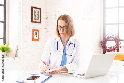 Mature female doctor working in doctor's office