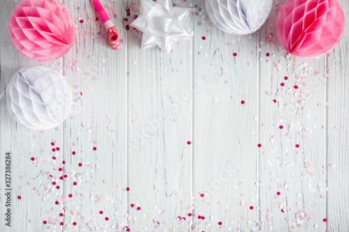 Background for congratulatory e-mail, pink banner on white wooden background. The basis for promotions, birthday. Party decorations. Flat lay, top view.