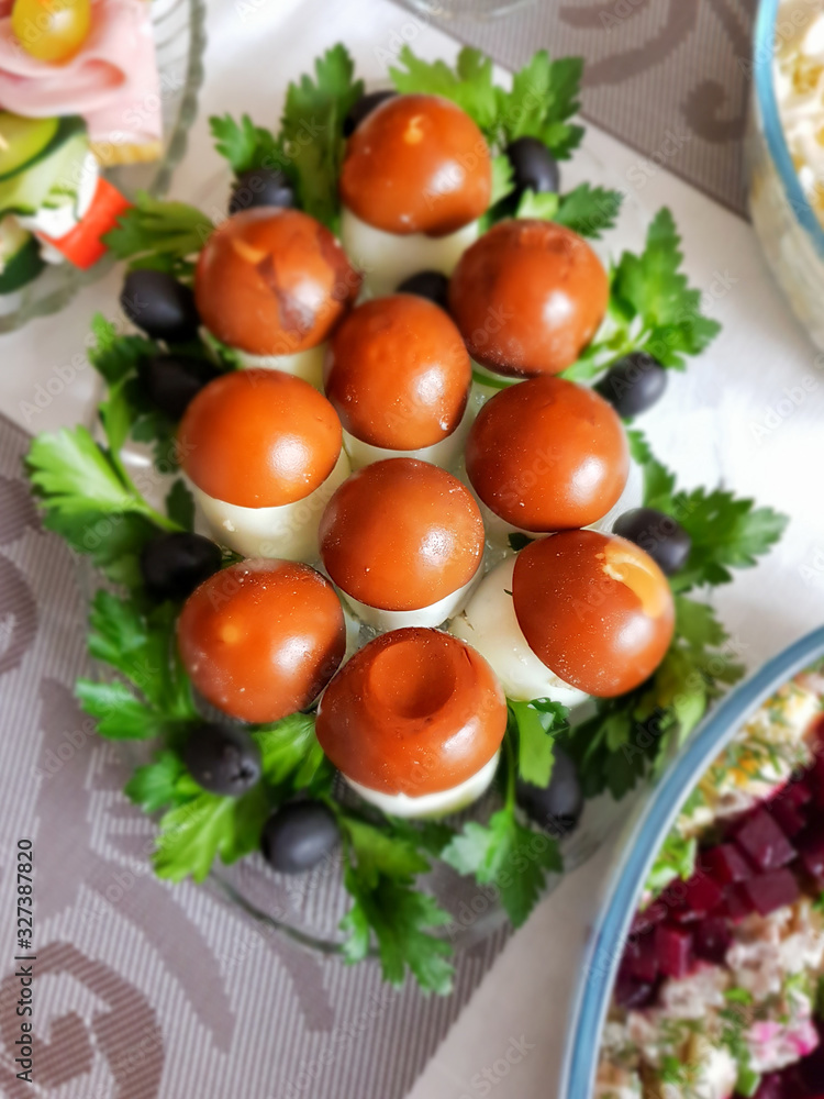 Funny mushrooms from painted eggs on the Easter table, with parsley and olives. Holiday snack. Funny mushrooms from painted eggs on the Easter table, with parsley and olives. Holiday snack.