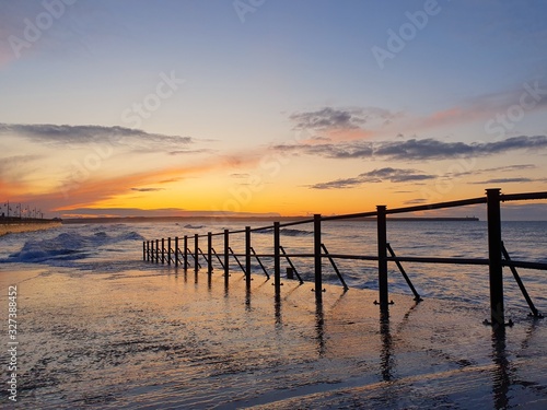 Sunrise over pier peaceful water tramore ireland