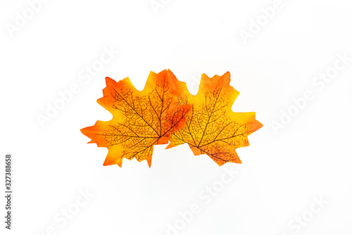 plastic artificial maple leaf made from fabric isolated on white background