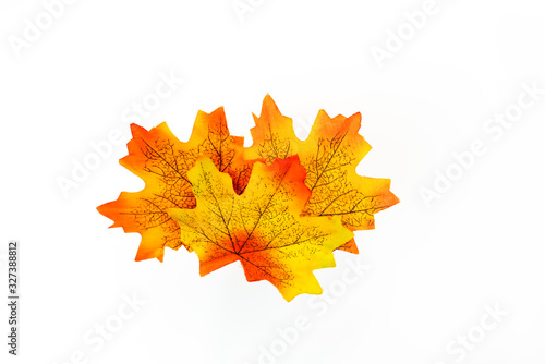 plastic artificial  maple leaf made from fabric isolated on white background