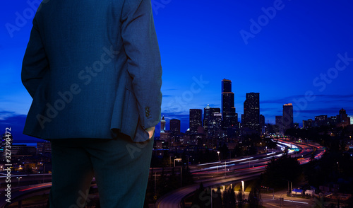 Back of businessman in suit standing near the window of downtown of Seattle, Washington, USA