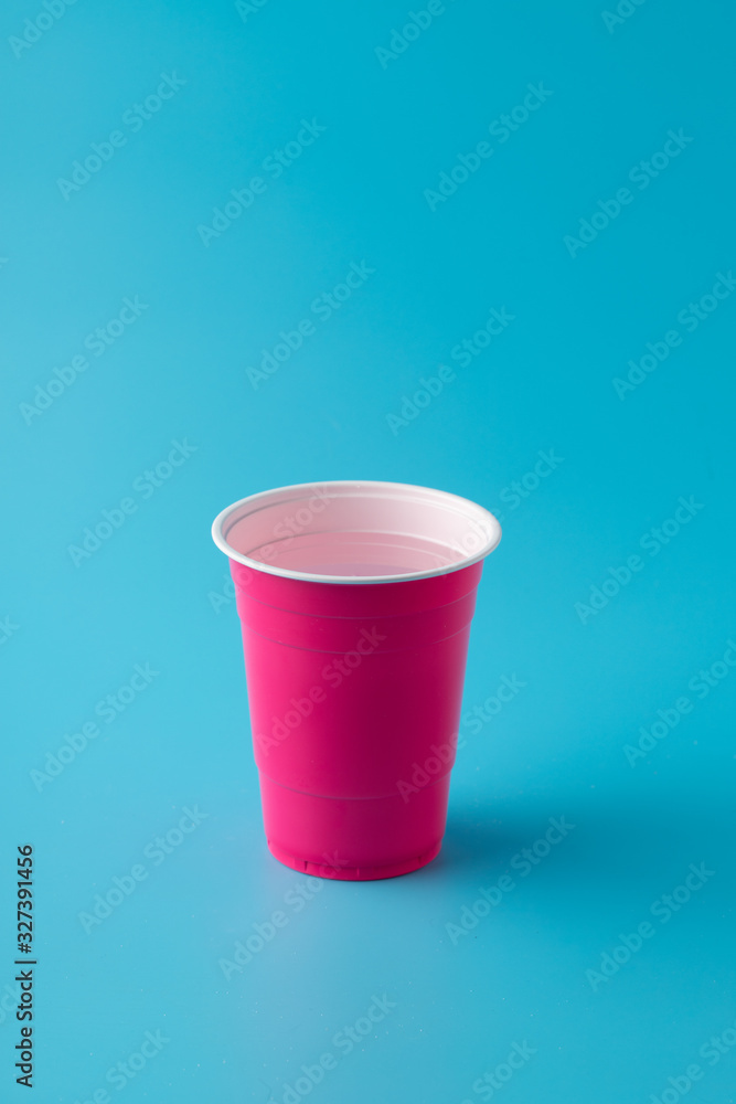 pink american cup on blue background, vertical pink american cup on blue background, vertical