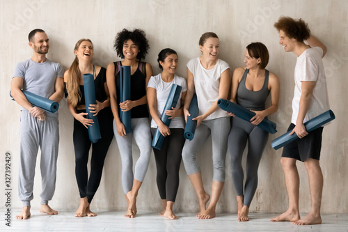 Young multiethnic people wear stylish activewear ready for yoga class