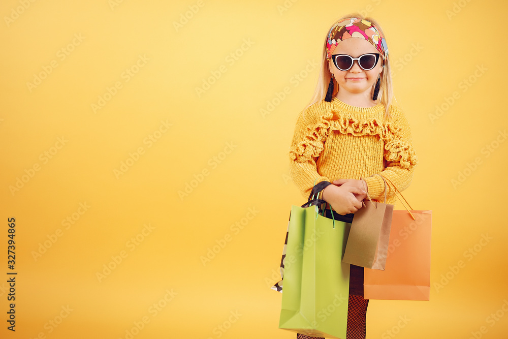 Child with shopping bags. Lady in a yellow sweater Child with shopping bags. Lady in a yellow sweater