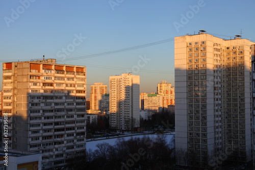 Moscow district of Konkovo, multi-storey residential buildings at winter evening with shadows from sun light