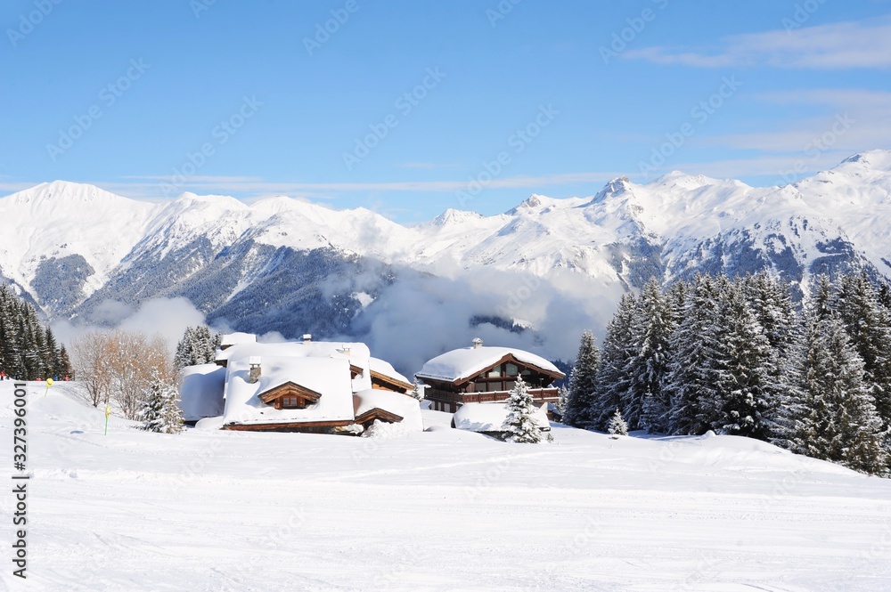 Winter scenery with chalet and snowy mountains 