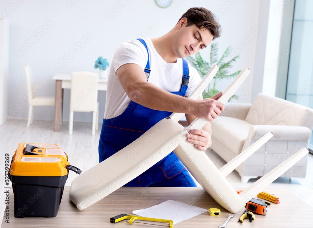 Obraz premium Man repairing chair in the room