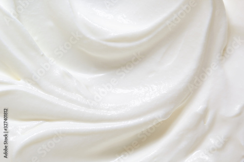 Sour cream, greek yogurt texture. White dairy product swirl closeup. Creamy healthy natural food macro photography. Top view photo