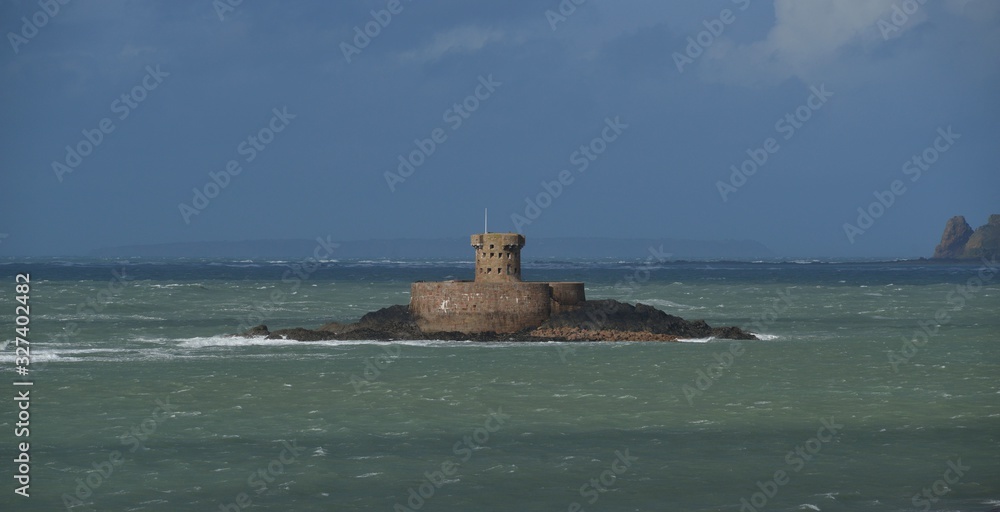 19th century Rocco Tower of St Ouen's Bay, Jersey, U.K. Winter dramatic weather.