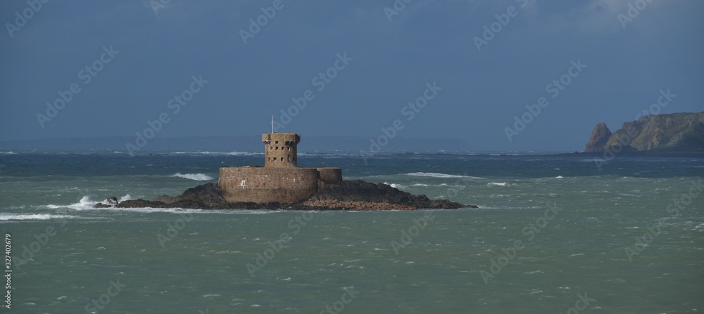 St Ouens Bay, Jersey, U.K. Telephoto image of a Wintery coast with a 19th century military tower, Rocco.