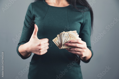 woman hand holding money and okay sign