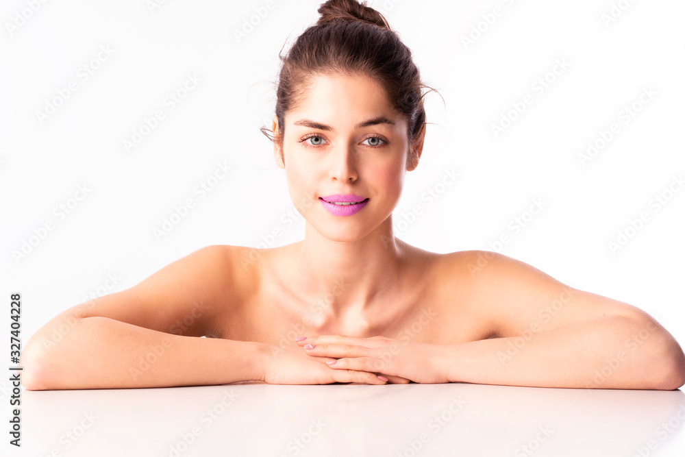 Beautiful young woman with perfect shin wearing purple lipstick at isolated white background Beautiful young woman with perfect shin wearing purple lipstick at isolated white background