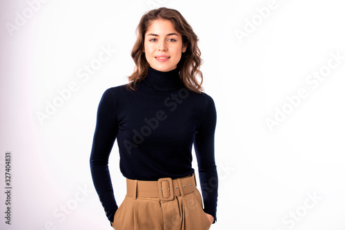 Cheerful and attractive young woman standing at isolated white background