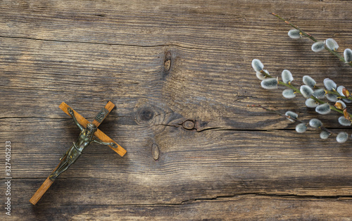 Willow branches with catkins on an old vintage wood from above. Easter background layout with free text space.