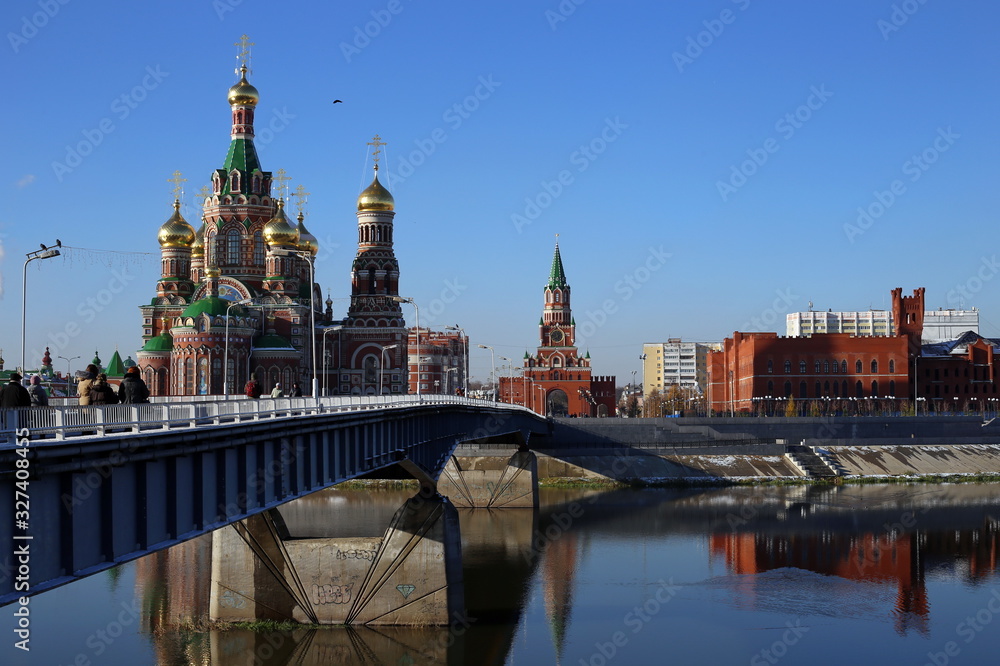 Fototapeta premium Cathedral of the Annunciation of the Blessed Virgin Mary. city of Yoshkar-Ola, Mari El Republic, Russia. Buildings are reflected in the water. Architecture of the city of Yoshkar-Ola