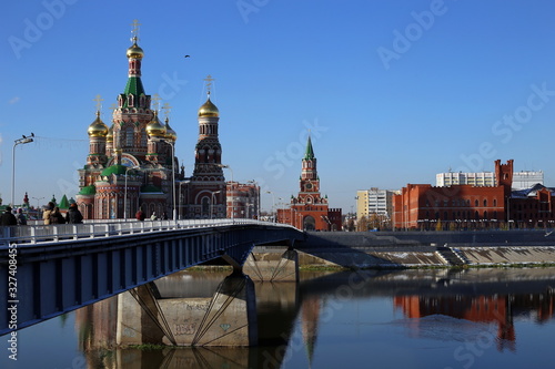 Cathedral of the Annunciation of the Blessed Virgin Mary. city of Yoshkar-Ola, Mari El Republic, Russia. Buildings are reflected in the water. Architecture of the city of Yoshkar-Ola