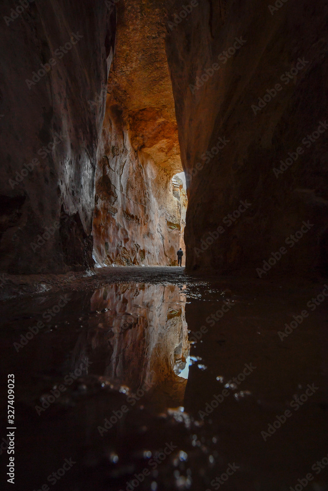 Reflection from a puddle at the bottom of the antique underground reservoir in NP Zippori, Galilee, Israel