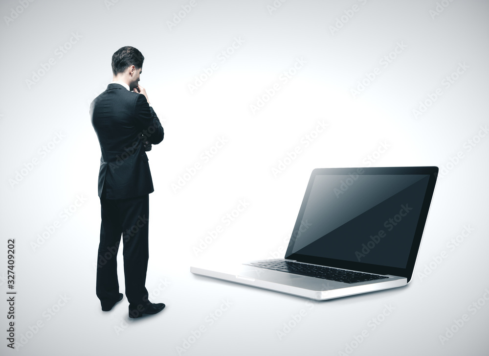 Businessman looking on laptop Businessman looking on laptop