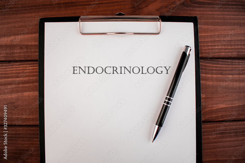 Word endocrinology: text written on a shit of paper of notebook on the wooden background. Medical concept. Word endocrinology: text written on a shit of paper of notebook on the wooden background. Medical concept.