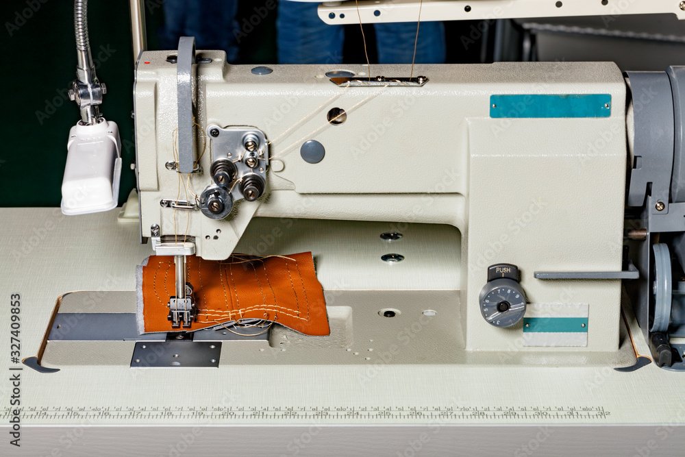 Industrial sewing machine for the manufacture of furniture upholstery from leather and other dense fabrics.