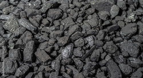 Anthracite is the best type of hard coal. Panoramic background from pieces of anthracite. Selective focus.