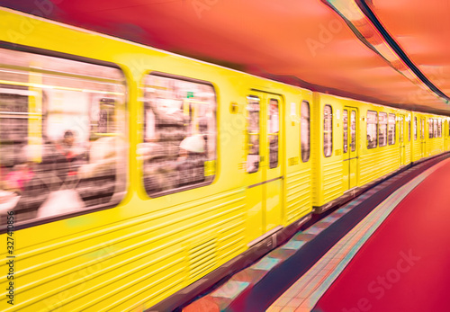 yellow subway train rides at the station