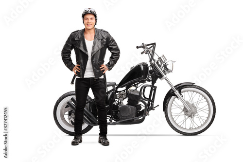 Biker posing next to a customized chopper motorbike