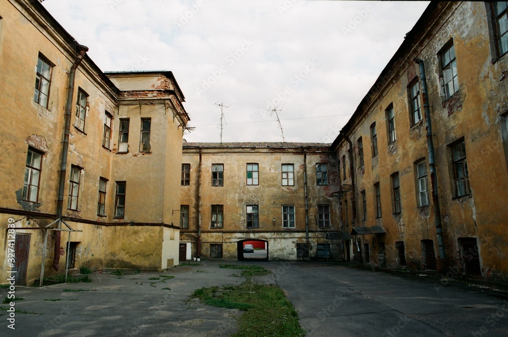 Sullen cityscape. Empty yard with abandoned old brick houses in rainy day Saint-Petersburg, Russia