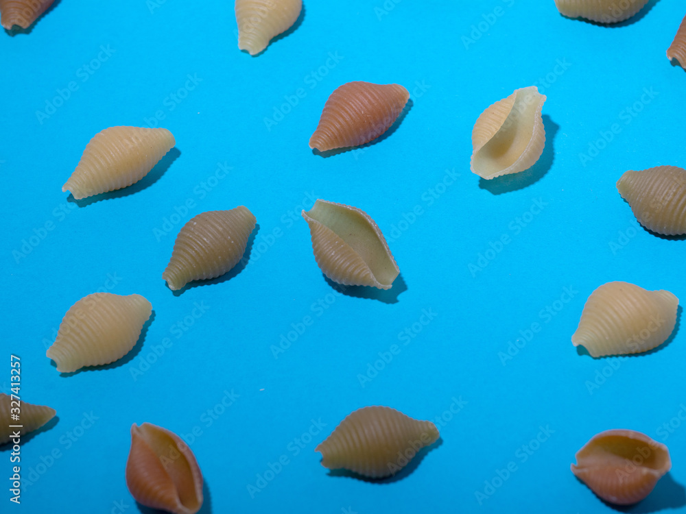 snail macaroni on a blue background. abstract background of pasta.