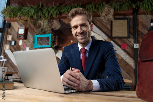 happy young businessman touching hands and smiling