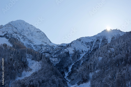New winter season has began. Snowy mountain peaks landscape. Cloudless sky. Russia, Sochi