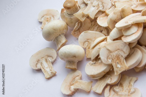 Fresh cut mushrooms spilled at the white background