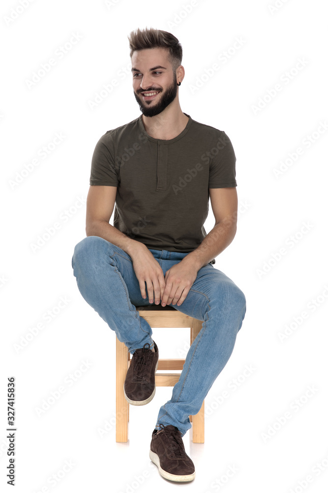 Cheerful casual man laughing while sitting Cheerful casual man laughing while sitting