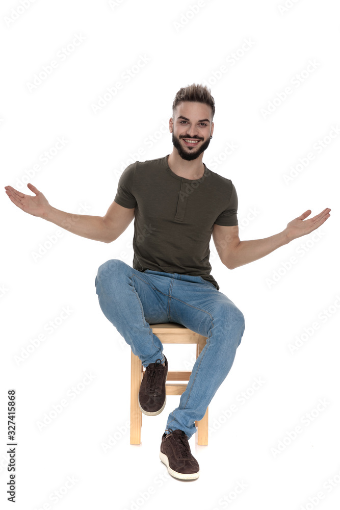 Positive casual man welcoming with his arms wide Positive casual man welcoming with his arms wide