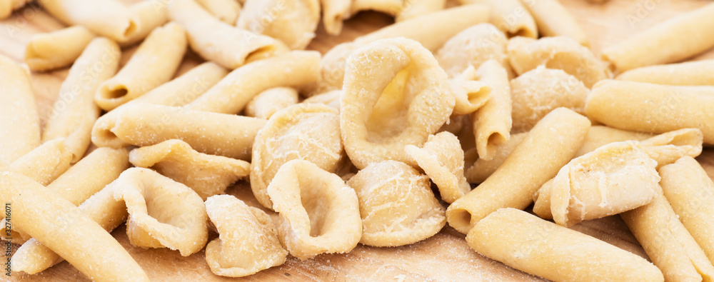 Homemade raw apulian pasta background of italian pasta called Orecchiette and Maccheroni, typical dish of Southern Italy, Puglia, Salento Homemade raw apulian pasta background of italian pasta called Orecchiette and Maccheroni, typical dish of Southern Italy, Puglia, Salento